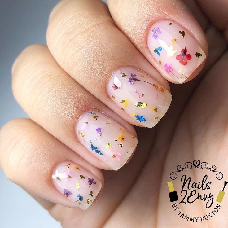 Playful Floral Nail Design with Glitter Confetti for a Whimsical Spring/Summer Look.