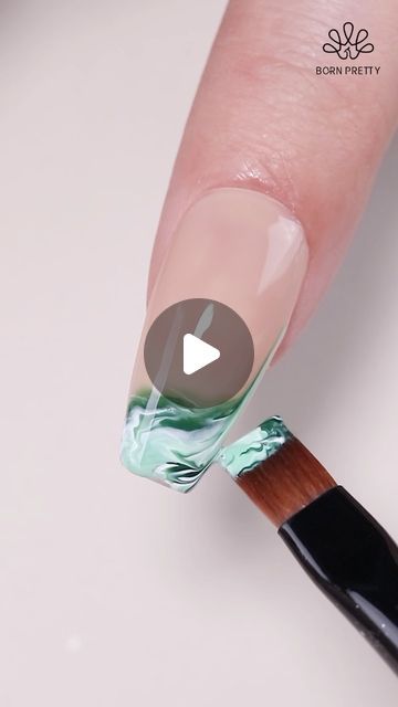 Elegant Fluid Marble Nail Art in Soft Green and White Tones.