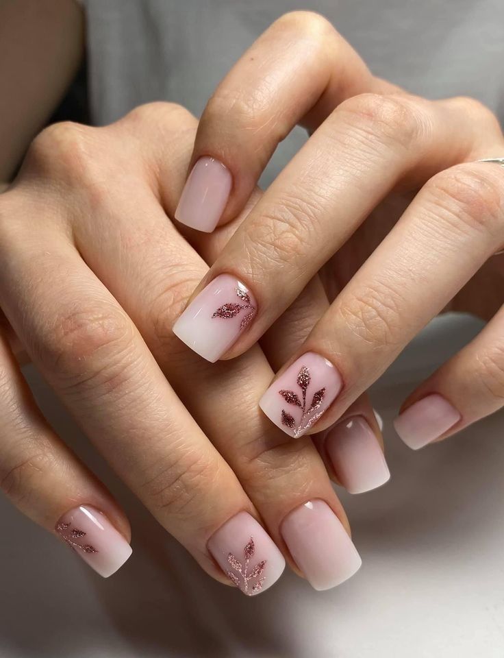 Sophisticated Ombre Nail Design with Rose Gold Glitter Accents.