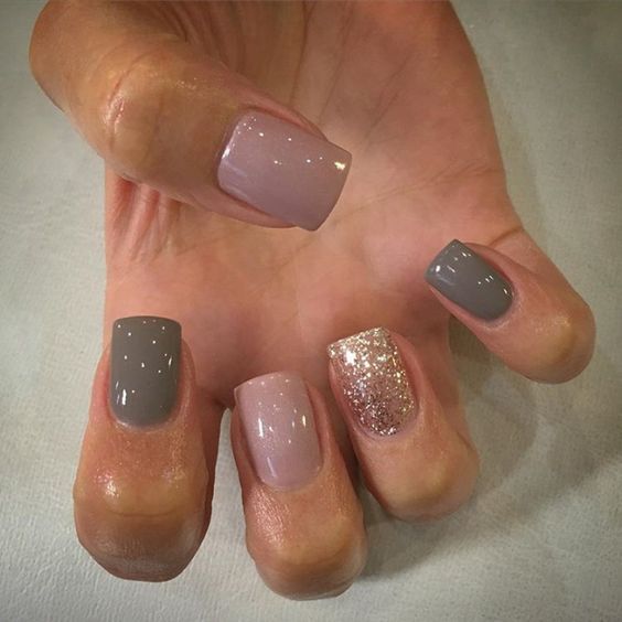 Chic Nail Design: Soft Muted Colors with Glamorous Glitter Accents.