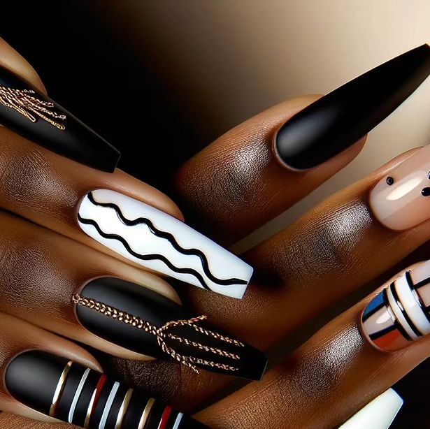 Chic Matte Black and Glossy White Nail Design with Modern Line Art and Metallic Accents.