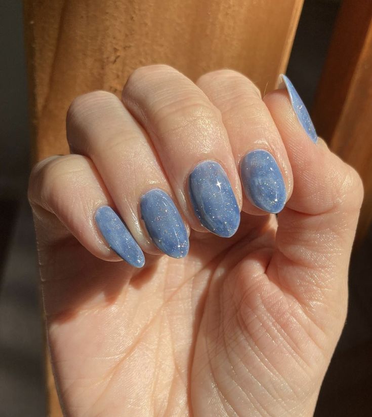 Elegant Sleek Blue Nail Design with Glossy Finish and Whimsical Sparkling Accents