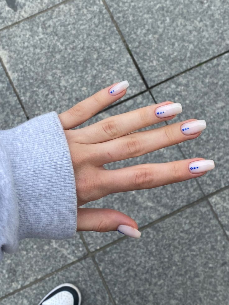 Sophisticated Ombre Nail Design with Playful Blue Accents