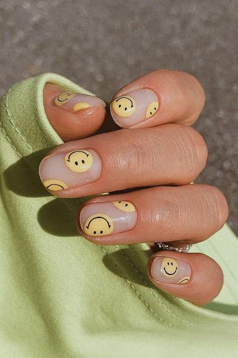 Playful Smiley Face Nail Design with Soft Yellow Accents for a Fresh, Cheerful Look.