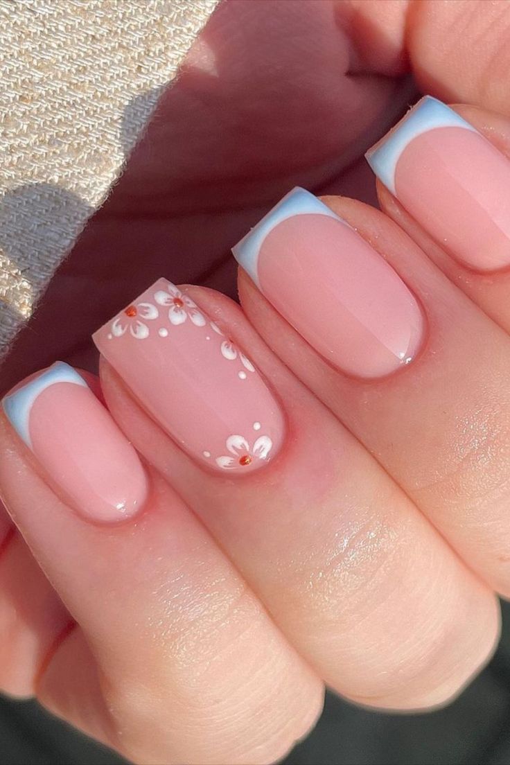 Chic Manicure: Soft Pink and Light Blue French Tips with Floral Accents