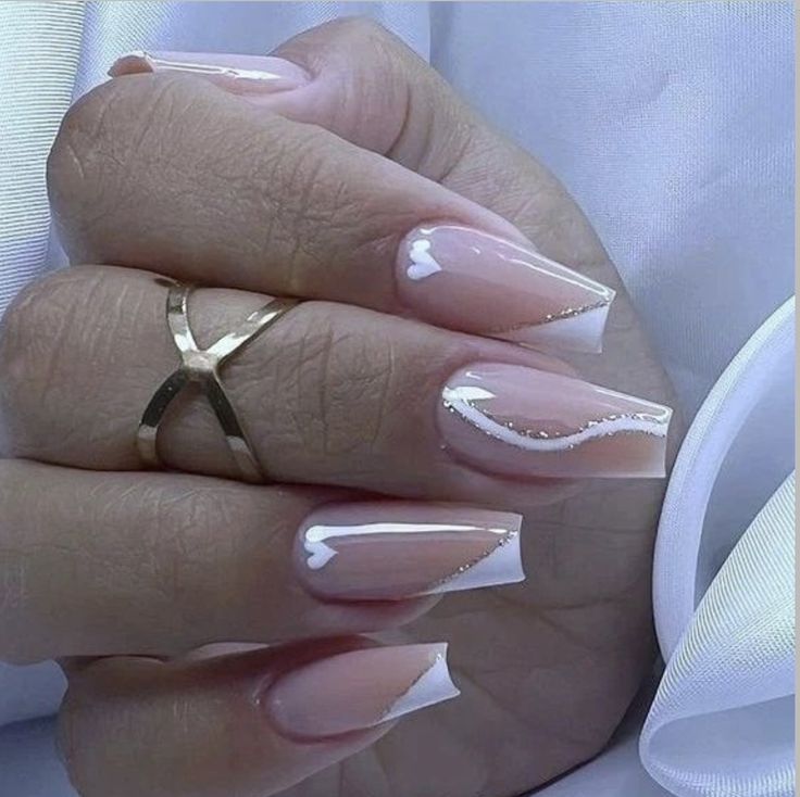 Chic Elegant Nude French Tip Nails with Romantic Heart Accents and Gold Detailing.