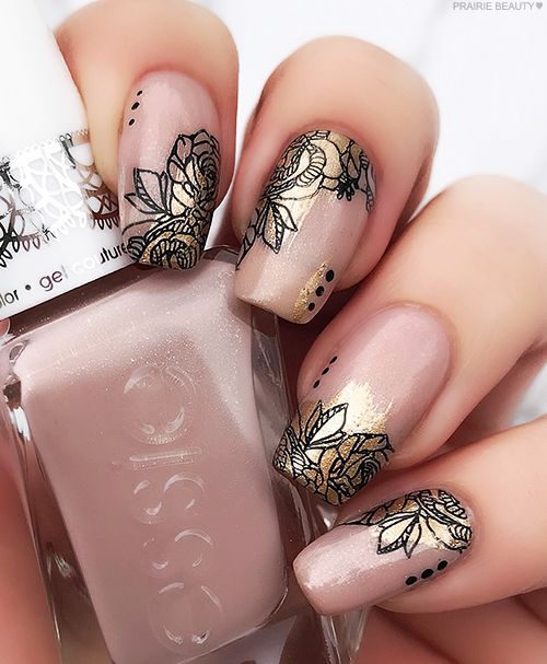 Elegant Floral Nail Design with Intricate Black Outlines and Gold Accents