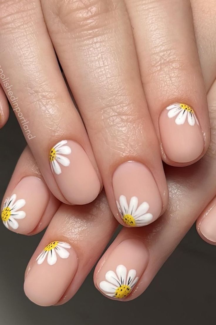 Charming Floral Nail Design with Delicate Daisies on Soft Nude Base