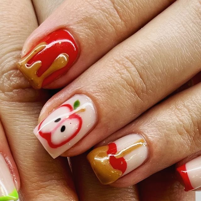 Vibrant Playful Apple-Themed Nail Design with Whimsical Illustrations and Mixed Finishes.