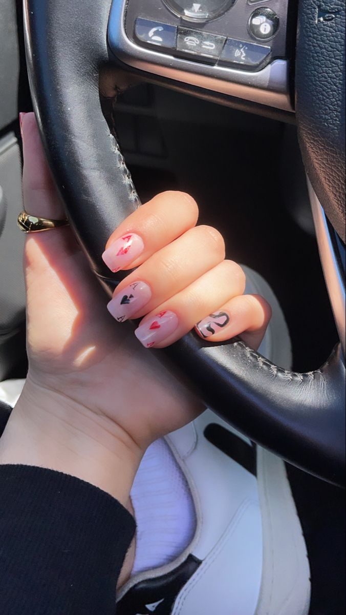 Charming Whimsical Nail Design: Soft Pink Base with Playful Heart Accents.