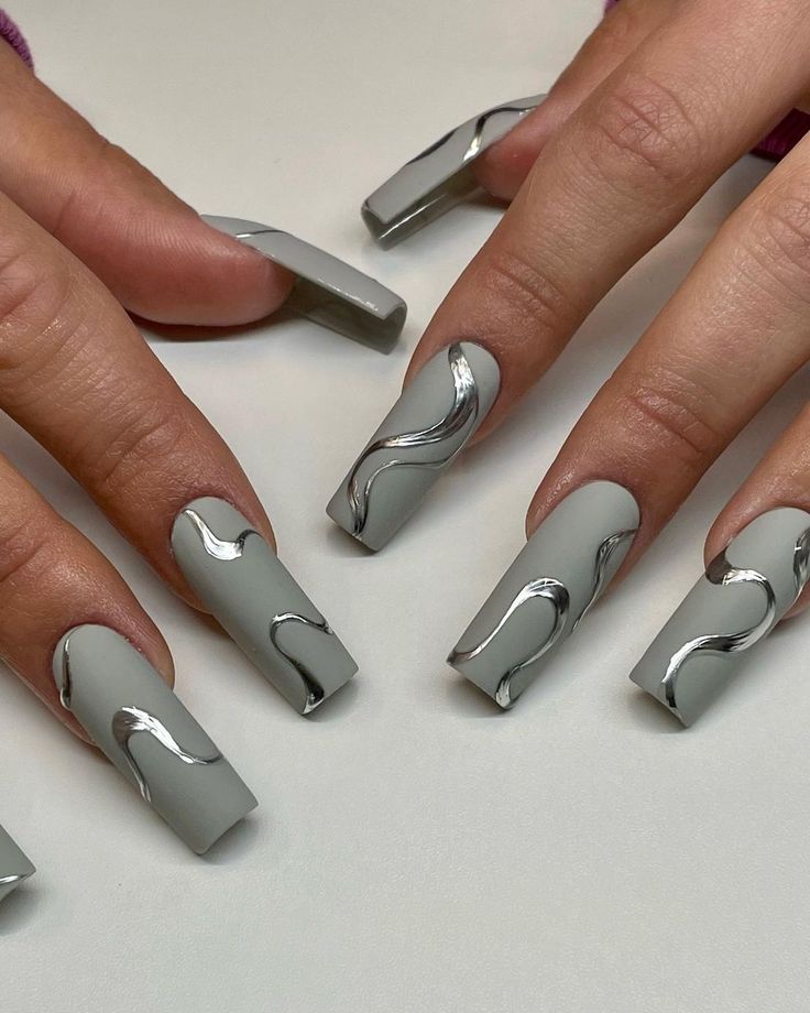 Stylish Matte Gray Nails with Metallic Waves for Modern Elegance.