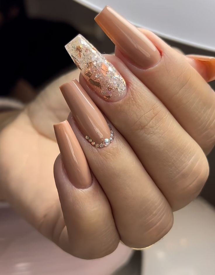 Chic Matte Nail Design with Nude and Glitter Accents and Rhinestone Elegance