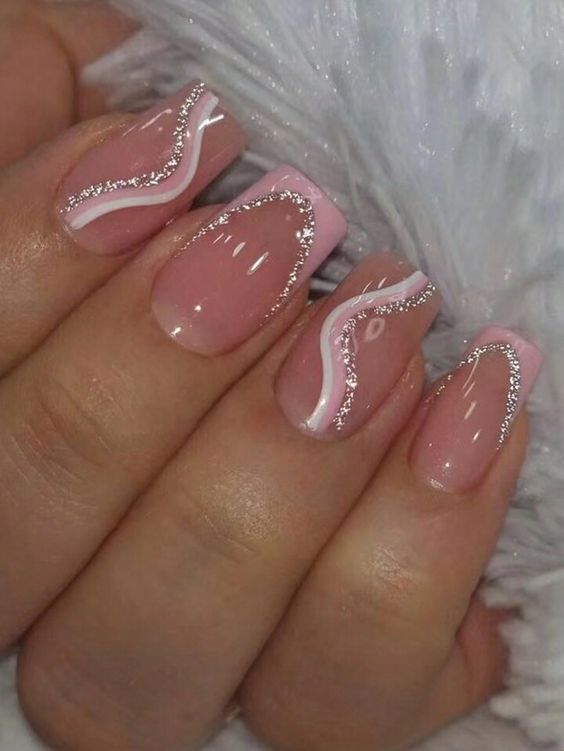 Sophisticated Soft Pink Nail Design with Whimsical White Lines and Sparkling Glitter Accents