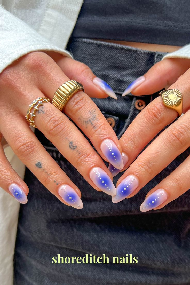 Dreamy Gradient Blue Nail Design with Whimsical White Dots in Elegant Almond Shape.