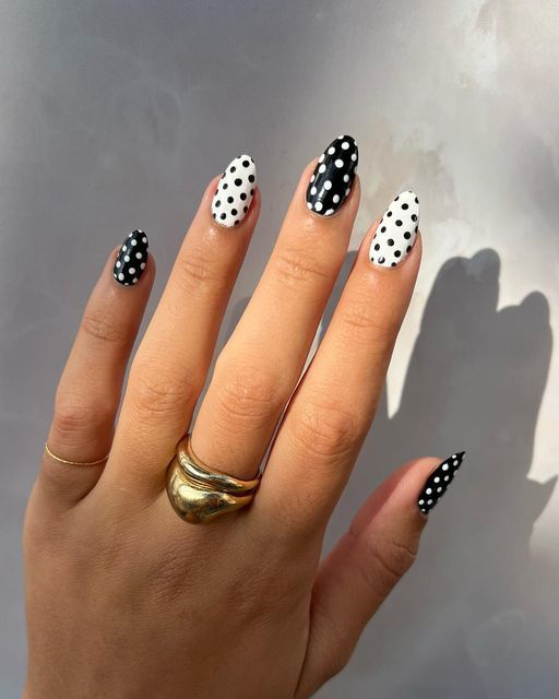 Stylish Monochrome Polka Dot Nail Design with Dynamic Black and White Dots