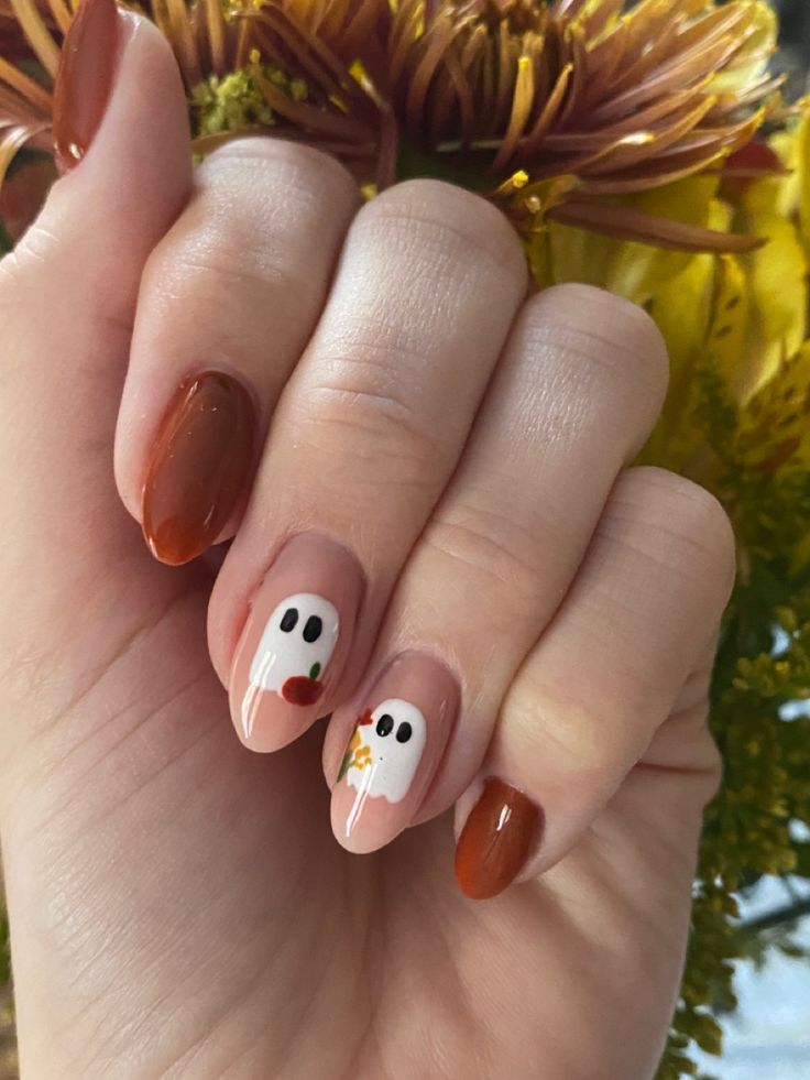 Festive Playful Ghost-Themed Nail Design in Neutral and Reddish-Brown Shades