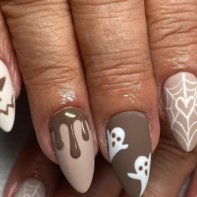 Charming Almond-Shaped Halloween Nail Design with Spooky-Sweet Motifs in a Muted Palette.