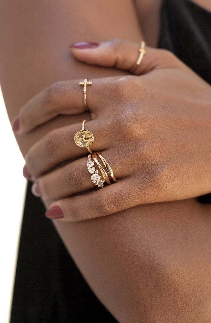 Chic Burgundy Nail Design Paired with Elegant Gold Rings for a Sophisticated Look.