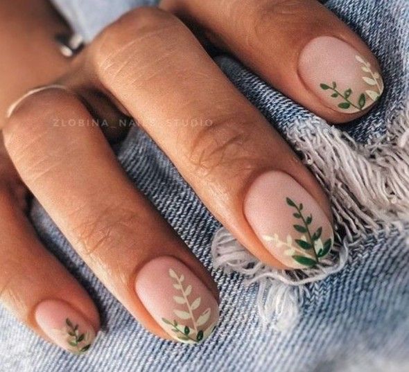 Elegant Botanical Nail Design with Intricate Leaf Patterns on Soft Beige Background.