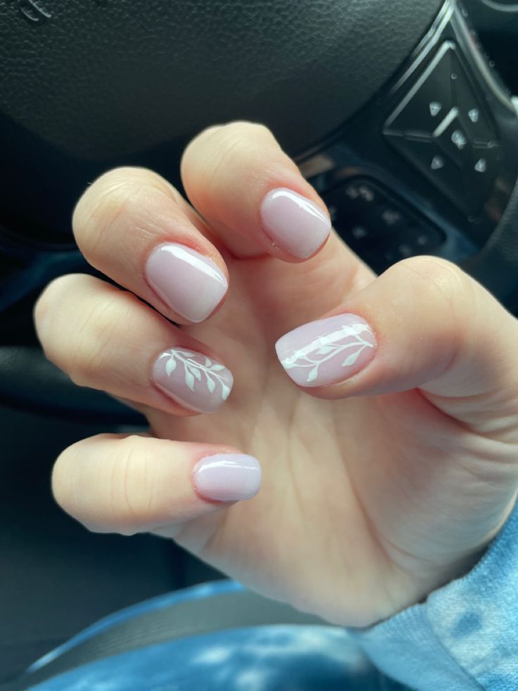 Elegant Soft Pink Nail Design with Artistic White Leaf Accents