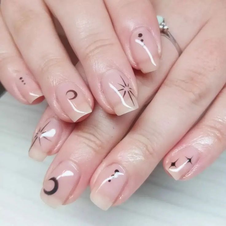 Chic Celestial Nail Design: Neutral Base with Minimalist Black Symbols