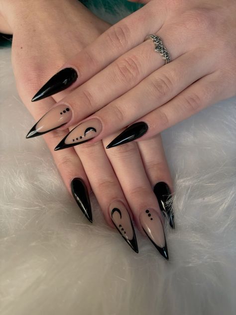 Sophisticated Black and Nude Stiletto Nail Design with Intricate Patterns.