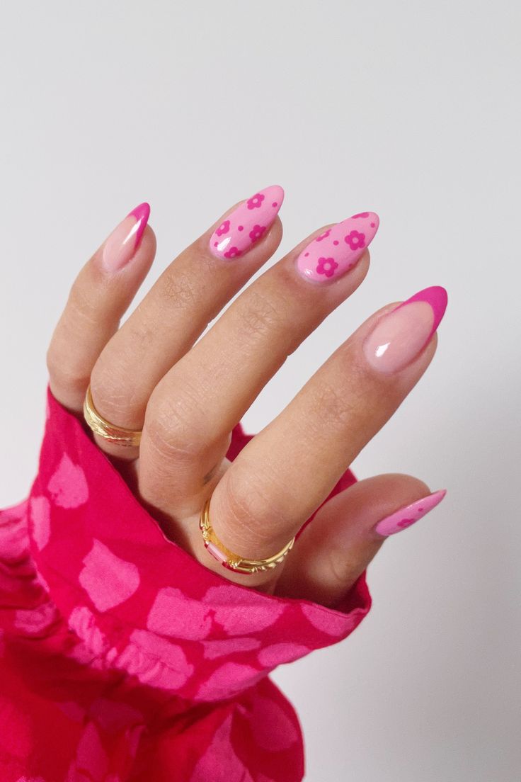 Vibrant Floral Nail Art: Pink Hues, Glossy Finish, and Whimsical French Tips.