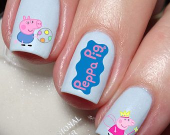 Playful Peppa Pig Nail Art: Colorful Designs on a Light Blue Background.