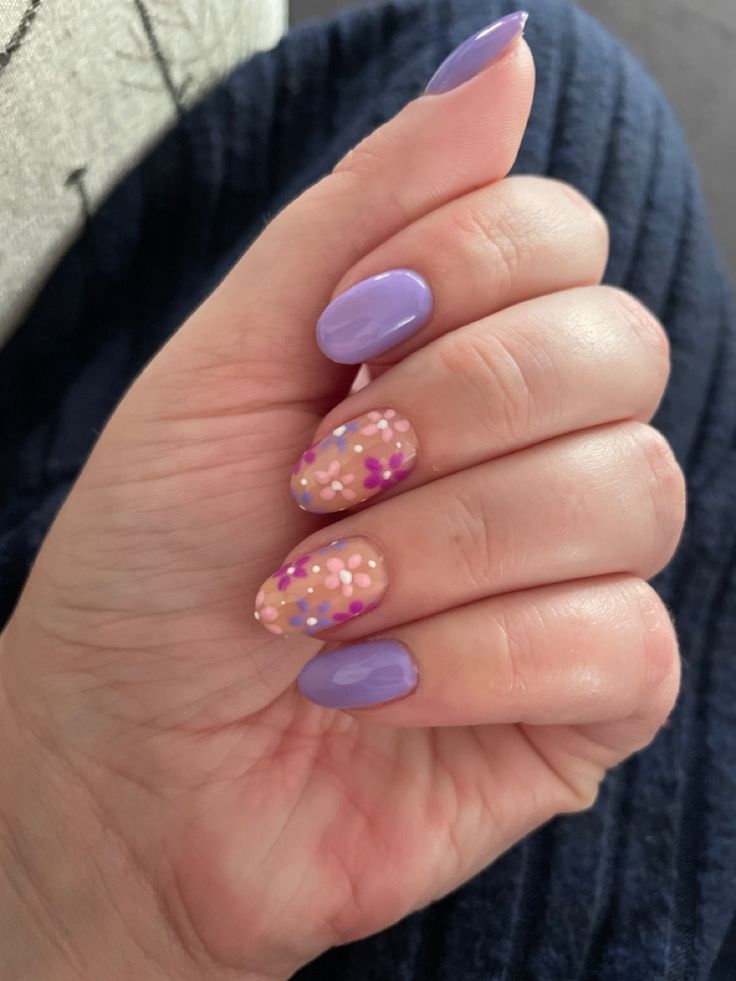 Vibrant Lavender and Pastel Nail Design with Floral Accents for a Cheerful Look.