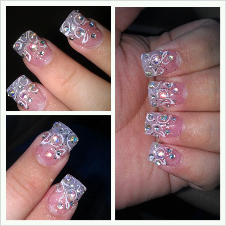 Sophisticated Soft Pink Nail Design with Intricate Patterns and Sparkling Rhinestones.