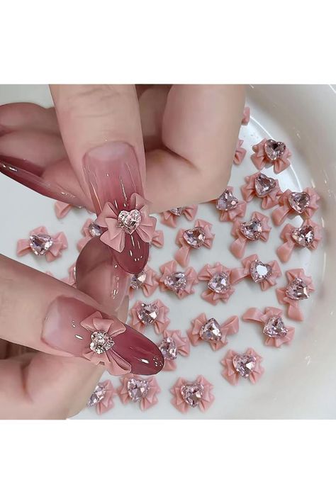 Elegant Pink and Nude Nail Design with Floral Embellishments and Sparkling Gems.