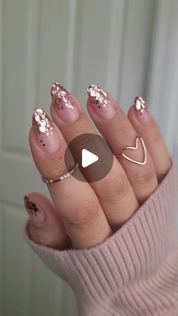 Chic Nude Nail Design with Dazzling Glitter and Sequin Accents.