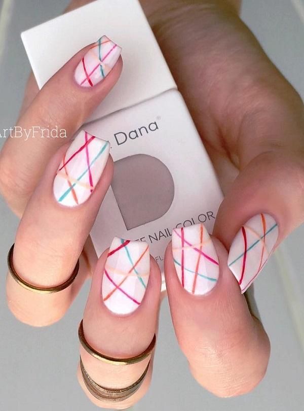 Vibrant Geometric Nail Design on White Base with Metallic Accents.