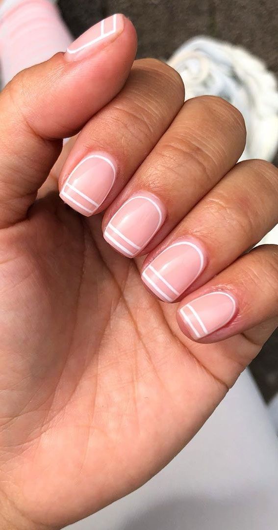 Chic and Modern Soft Pink Nail Design with White Accents.