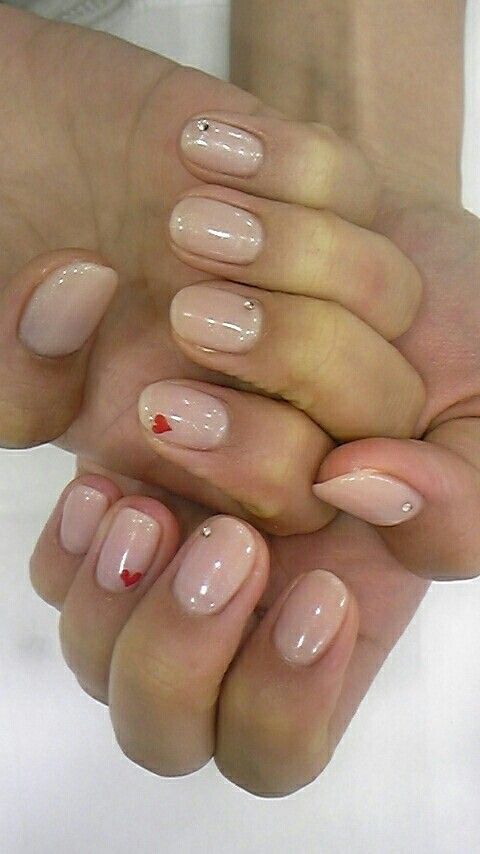 Chic Nude Nail Design with Rhinestones and Playful Heart Accents for Special Occasions