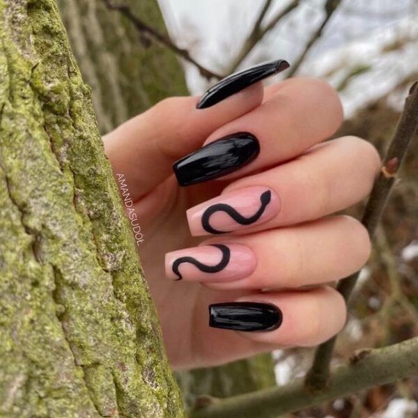 Sleek Matte Black and Nude Nail Design with Elegant Swirls for a Striking Look