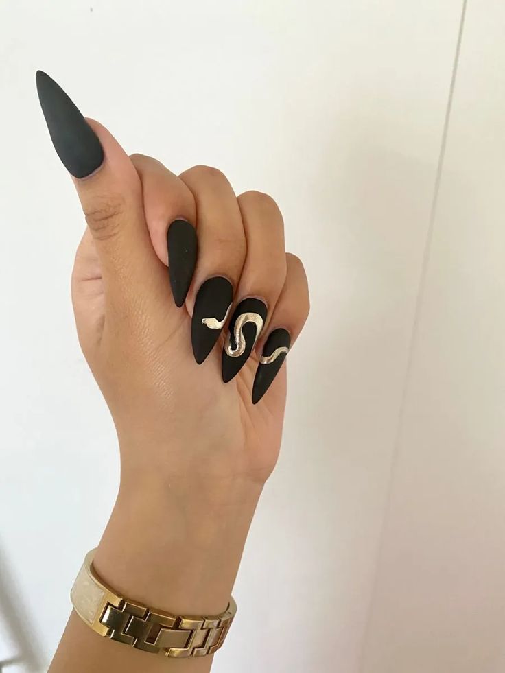 Bold Matte Black Nails with Metallic Snake Design and Gold Watch for an Edgy Sophistication.