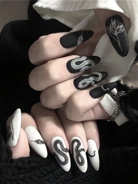 Chic Monochrome Nail Design with Intricate Snake and Floral Patterns.