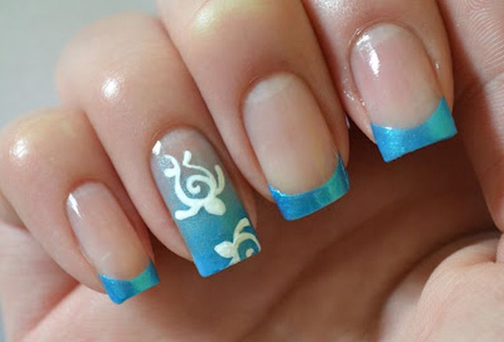 Stylish Gradient Blue Nail Design with Delicate White Patterns.