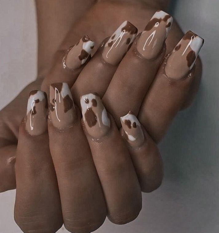 Trendy Cow Print Nail Design with Glossy Finish for a Playful, Elegant Statement.