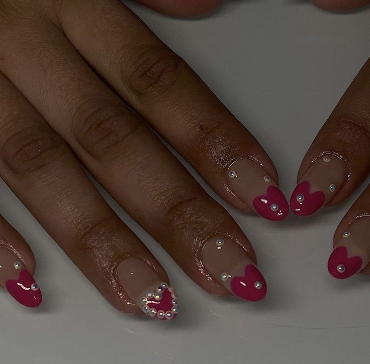 Vibrant Pink Heart Nail Design with Playful Gems for a Festive Flair.