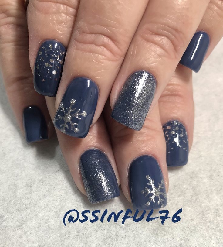 Elegant Winter Nail Design: Deep Navy Base with Silver Gradient and Snowflakes.