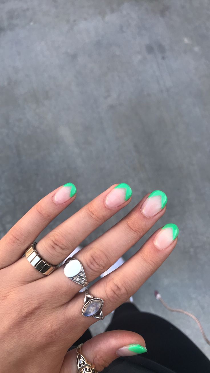 Chic French Tip Nails Enhanced with Bold Neon Green Accents.