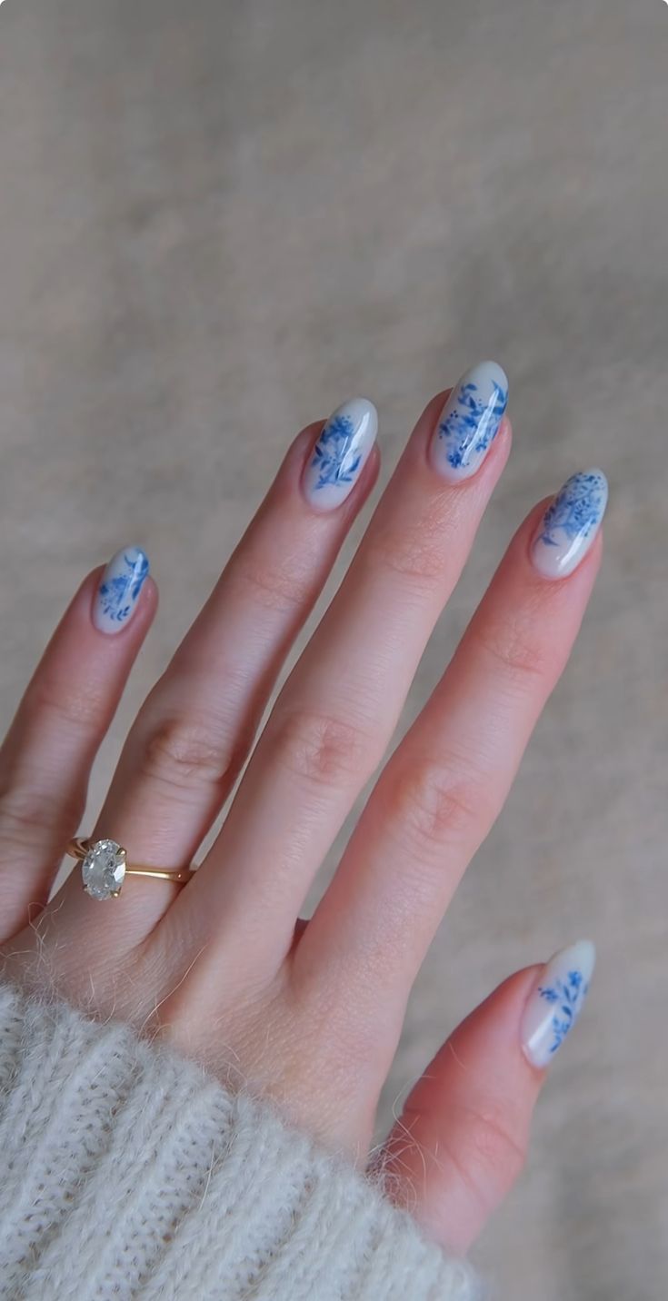 Elegant Floral-Patterned Nail Design with Delicate Blue Accents.