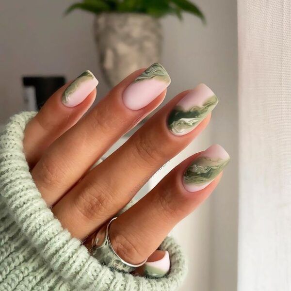 Chic Marble-Inspired Nail Design in Soft Green and Pale Pink Tones.