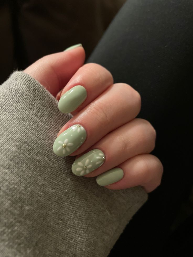 Charming Mint Green Nails with Floral Accents for a Fresh Feminine Touch.