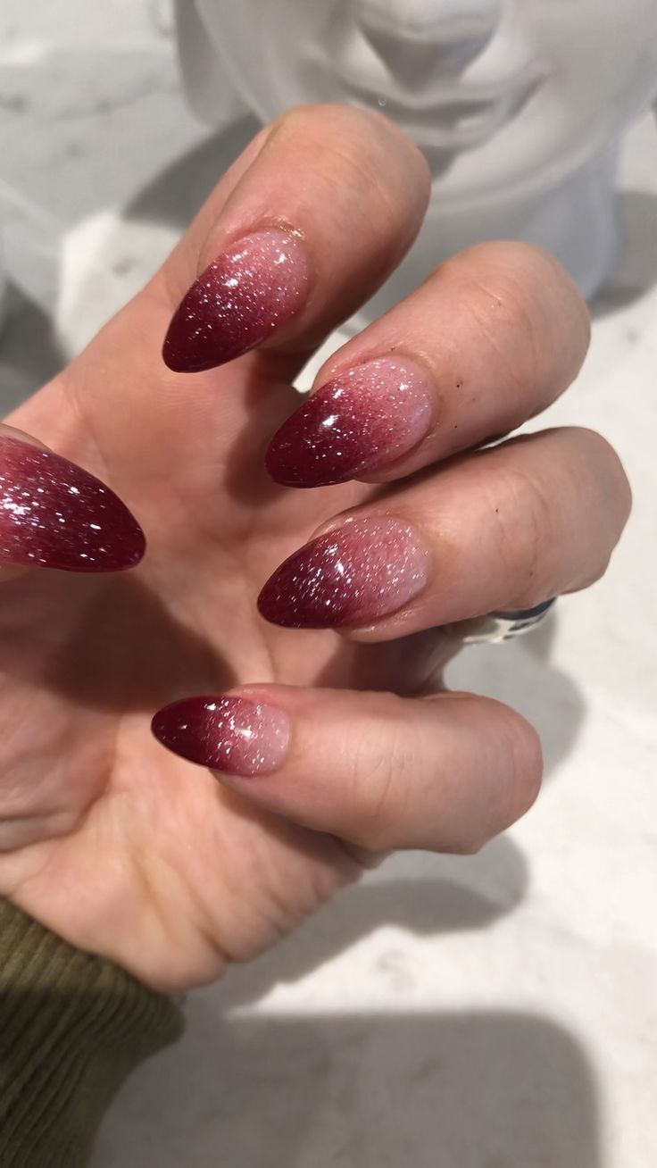 Elegant Ombre Nail Design: Deep Burgundy and Soft Pink with Glittery Finish for a Luxurious Look.