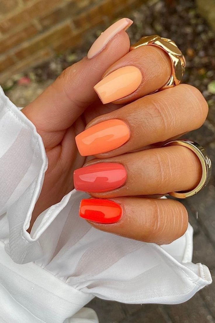 Cheerful Summer Gradient Nail Design in Peach, Coral, and Orange Shades.