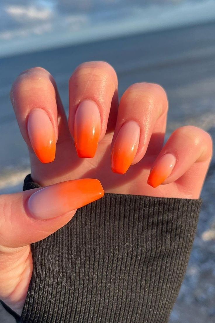 Vibrant Ombre Orange Nail Design: A Lively Gradient from Peach to Orange.