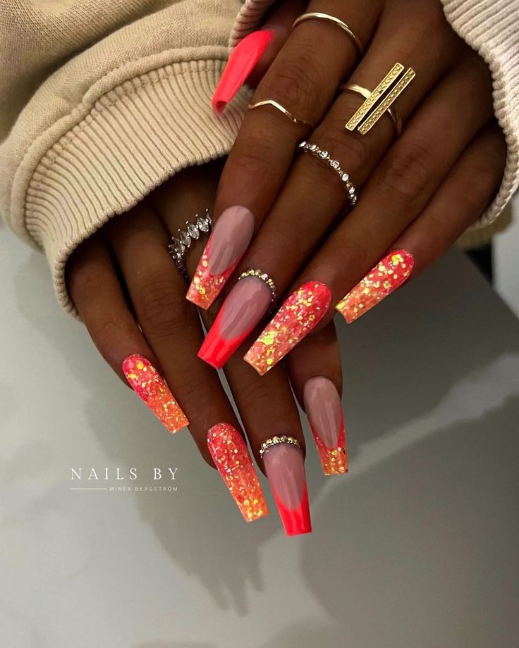 Chic Coral and Nude Gradient Nail Design with Glitter Accents and Bold Neon Tips.